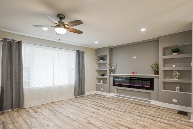 8040 S Lafayette Ave, Chicago, IL 60620 - unfurnished living room with wood finished floors, ceiling fan, a glass covered fireplace, built in shelves, and recessed lighting