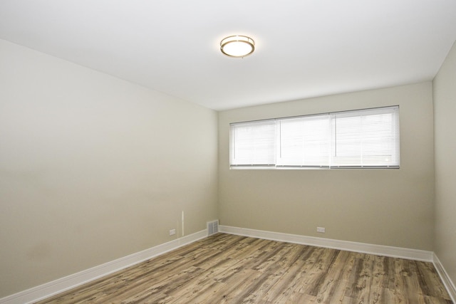 8040 S Lafayette Ave, Chicago, IL 60620 - spare room featuring wood finished floors and baseboards