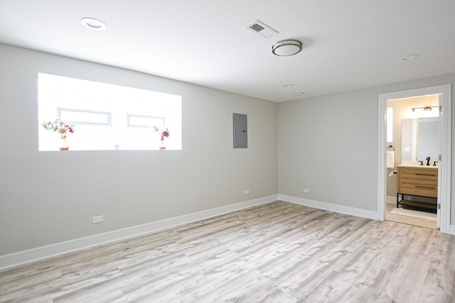 8040 S Lafayette Ave, Chicago, IL 60620 - unfurnished bedroom featuring electric panel, light wood-style flooring, baseboards, recessed lighting, and ensuite bath