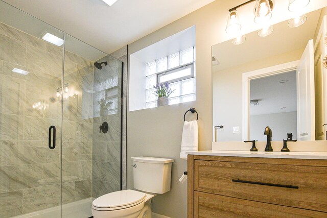 8040 S Lafayette Ave, Chicago, IL 60620 - full bathroom with toilet, vanity, a shower stall, and baseboards