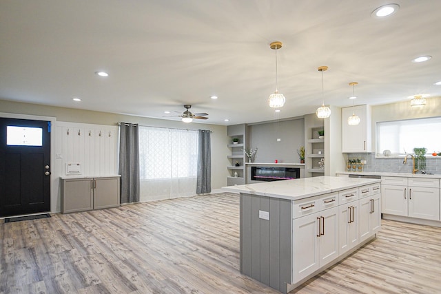 8040 S Lafayette Ave, Chicago, IL 60620 - kitchen featuring recessed lighting, light wood-style floors, a center island, white cabinetry, and healthy amount of natural light