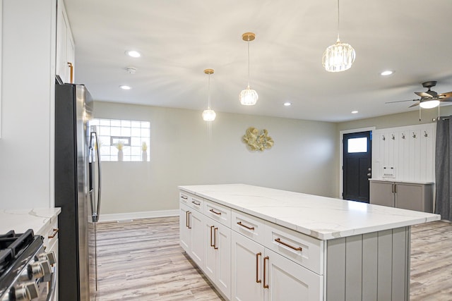 8040 S Lafayette Ave, Chicago, IL 60620 - kitchen featuring stainless steel fridge, ceiling fan, white cabinetry, a kitchen island, and light wood finished floors