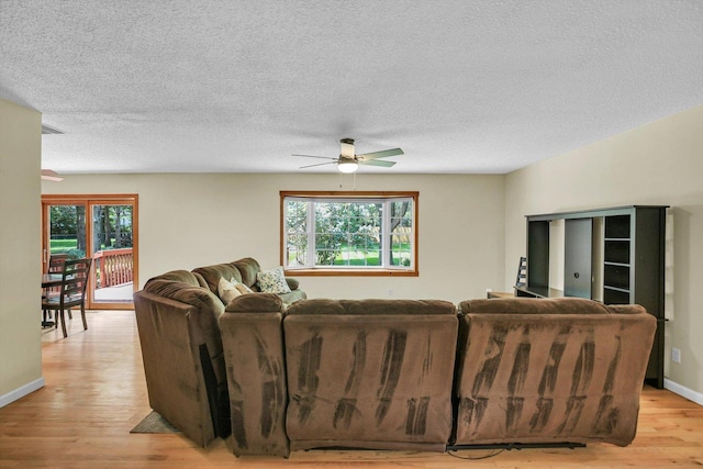 907 S Trailside Dr, Mahomet, IL 61853 - living area with ceiling fan, light wood-type flooring, healthy amount of natural light, and a textured ceiling