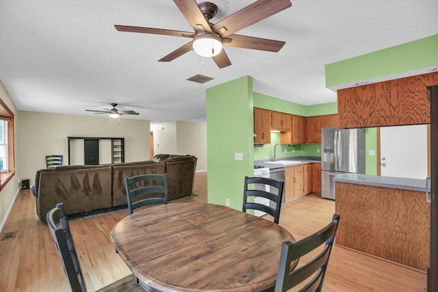 907 S Trailside Dr, Mahomet, IL 61853 - dining area with a ceiling fan, light wood-style flooring, and a textured ceiling