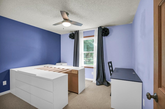 907 S Trailside Dr, Mahomet, IL 61853 - unfurnished bedroom featuring light colored carpet, a textured ceiling, and ceiling fan