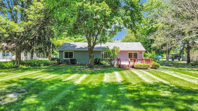 907 S Trailside Dr, Mahomet, IL 61853 - back of property with a deck, a lawn, and a chimney