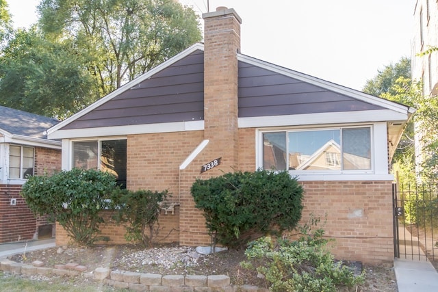 7338 S Campbell Ave, Chicago, IL 60629 - view of side of home with brick siding and a chimney