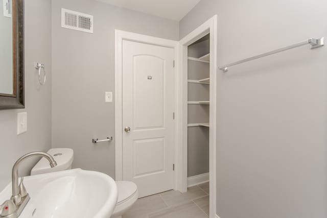 7338 S Campbell Ave, Chicago, IL 60629 - bathroom with a sink, toilet, and tile patterned flooring