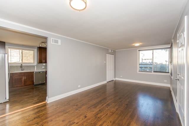 7338 S Campbell Ave, Chicago, IL 60629 - empty room featuring a sink, dark wood finished floors, ornamental molding, and baseboards