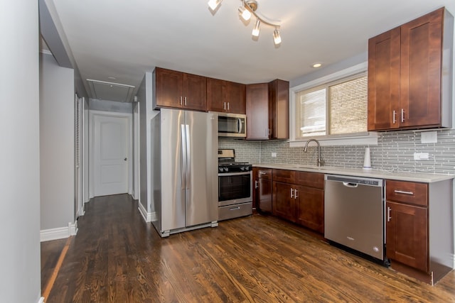 7338 S Campbell Ave, Chicago, IL 60629 - kitchen featuring appliances with stainless steel finishes, light countertops, tasteful backsplash, and dark wood-type flooring