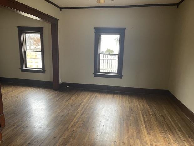 622 Clark St, Marseilles, IL 61341 - spare room with crown molding, dark wood finished floors, and baseboards