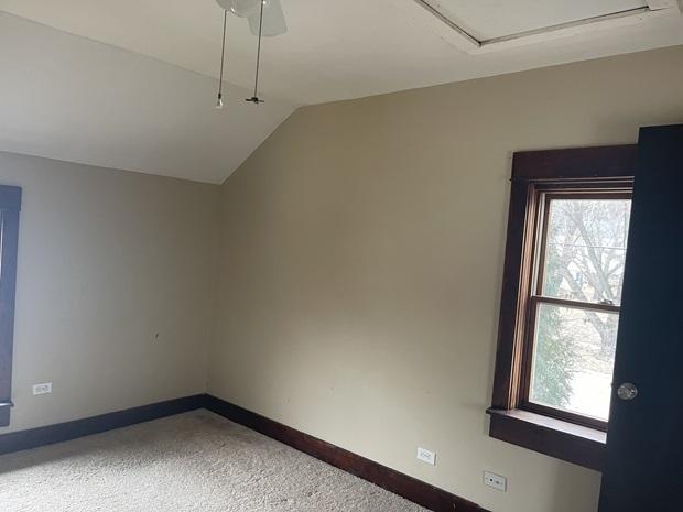 622 Clark St, Marseilles, IL 61341 - empty room with healthy amount of natural light, light carpet, vaulted ceiling, and baseboards
