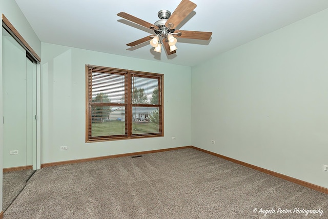 12401 Bigelow Ave, Hebron, IL 60034 - unfurnished bedroom featuring carpet floors, baseboards, a closet, and ceiling fan