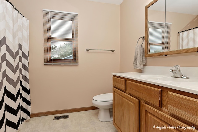 12401 Bigelow Ave, Hebron, IL 60034 - full bath with vanity, toilet, baseboards, and a shower with curtain