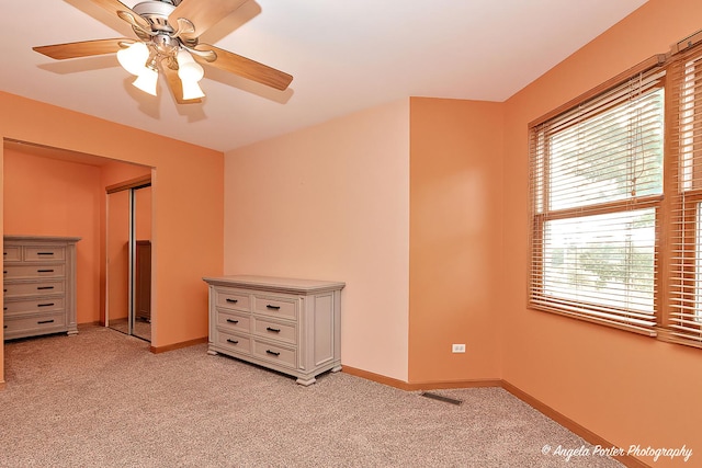 12401 Bigelow Ave, Hebron, IL 60034 - unfurnished bedroom with multiple windows, light carpet, and baseboards