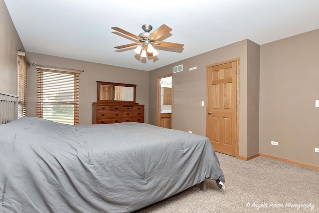 12401 Bigelow Ave, Hebron, IL 60034 - bedroom featuring light colored carpet, baseboards, a ceiling fan, and ensuite bathroom