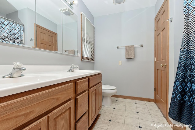12401 Bigelow Ave, Hebron, IL 60034 - bathroom featuring vanity, toilet, baseboards, tile patterned floors, and a shower with shower curtain