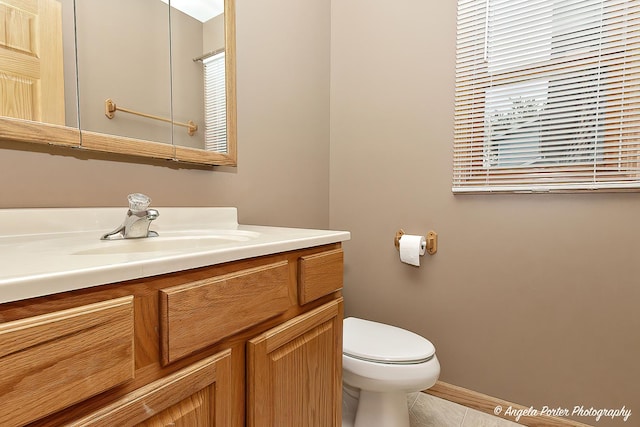 12401 Bigelow Ave, Hebron, IL 60034 - bathroom with vanity, toilet, tile patterned flooring, and baseboards