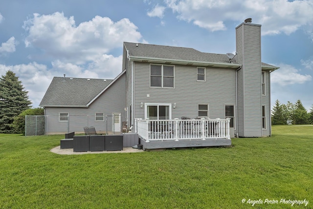 12401 Bigelow Ave, Hebron, IL 60034 - rear view of house featuring a chimney, a deck, a lawn, and roof with shingles