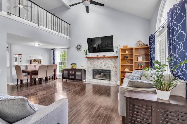 1911 Ozark Pkwy, Algonquin, IL 60102 - living room with high vaulted ceiling, a ceiling fan, wood finished floors, and a glass covered fireplace