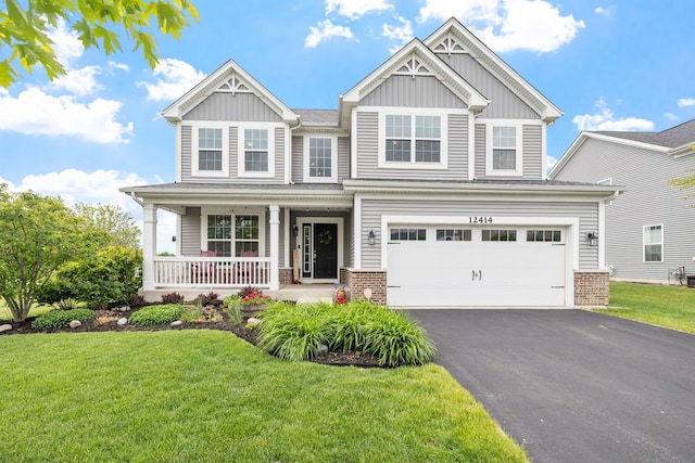12414 Dublin Ln, Plainfield, IL 60585 - craftsman house with board and batten siding, asphalt driveway, a porch, and a front yard