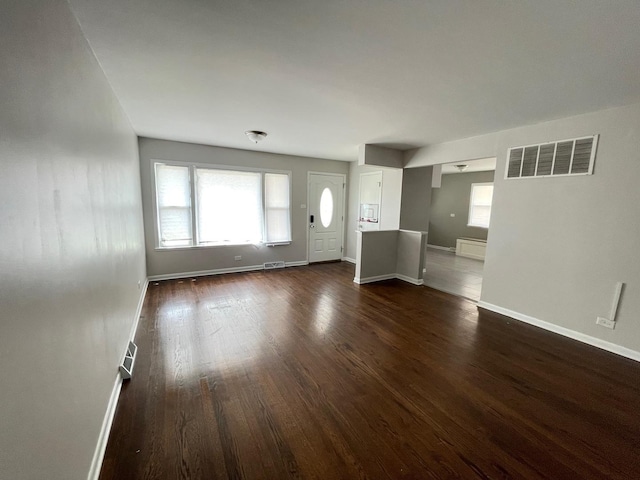 3914 153rd St, Midlothian, IL 60445 - unfurnished living room featuring dark wood-style floors, healthy amount of natural light, and baseboards