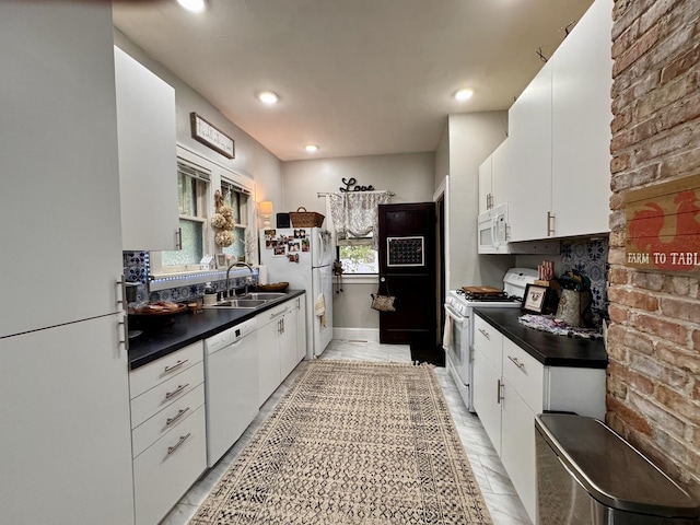 1118 W 4th St, Dixon, IL 61021 - kitchen featuring white appliances, a sink, dark countertops, white cabinetry, and recessed lighting