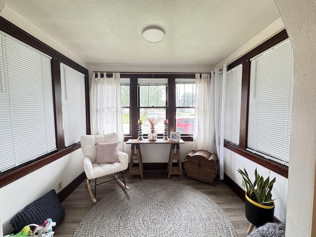1118 W 4th St, Dixon, IL 61021 - sunroom / solarium featuring a textured ceiling, wood finished floors, and baseboards