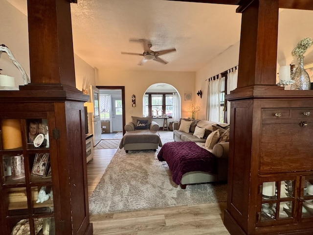 1118 W 4th St, Dixon, IL 61021 - living area featuring ceiling fan, wood finished floors, arched walkways, and a textured ceiling