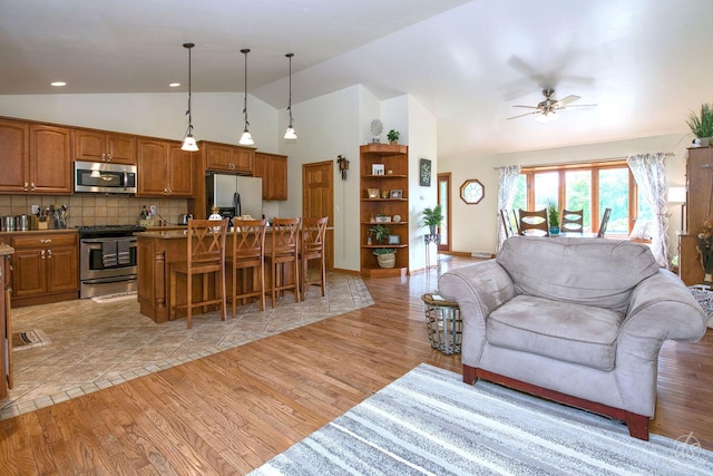 28671 Moose Range Rd, Sycamore, IL 60178 - living room featuring ceiling fan, light wood-style flooring, and high vaulted ceiling