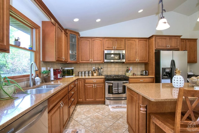28671 Moose Range Rd, Sycamore, IL 60178 - kitchen with stainless steel appliances, lofted ceiling, a sink, brown cabinetry, and light stone countertops