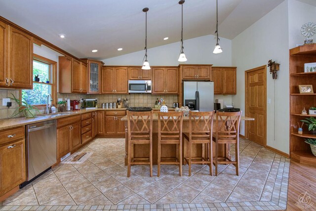 28671 Moose Range Rd, Sycamore, IL 60178 - kitchen with stainless steel appliances, a sink, brown cabinets, and high vaulted ceiling