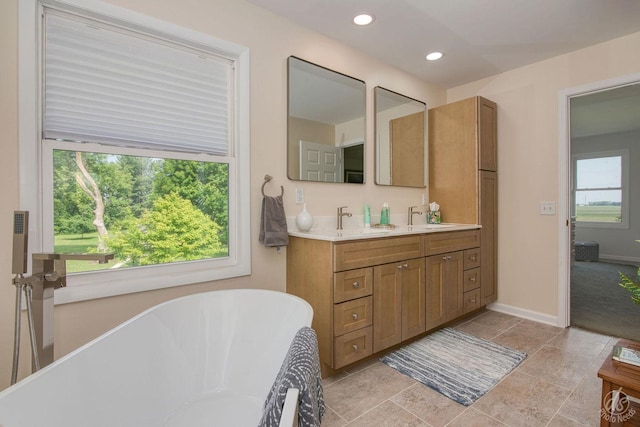 28671 Moose Range Rd, Sycamore, IL 60178 - full bathroom featuring a freestanding tub, double vanity, baseboards, and recessed lighting