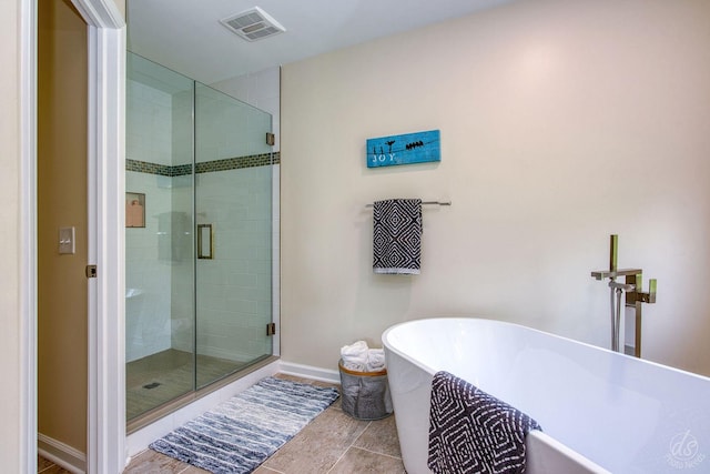 28671 Moose Range Rd, Sycamore, IL 60178 - bathroom featuring a freestanding tub, a stall shower, baseboards, and tile patterned floors