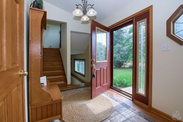 28671 Moose Range Rd, Sycamore, IL 60178 - foyer entrance featuring a chandelier, stairs, baseboards, and wood finished floors