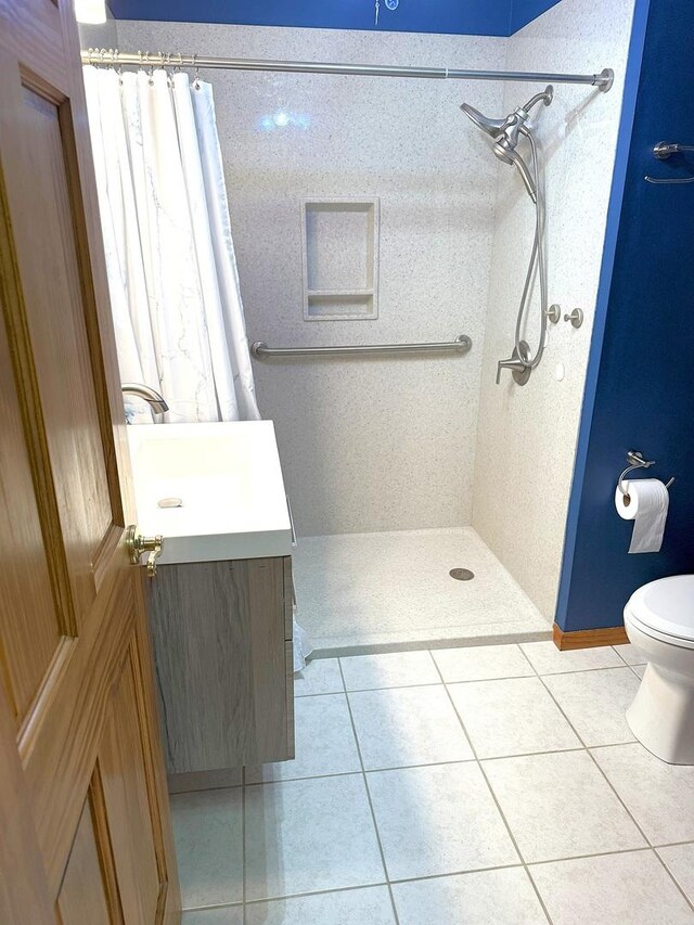1417 S College Ave, Dixon, IL 61021 - bathroom with vanity, curtained shower, tile patterned flooring, and toilet