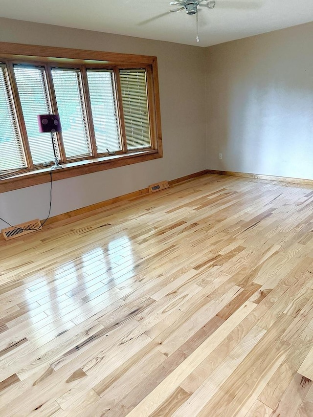 1417 S College Ave, Dixon, IL 61021 - spare room featuring wood finished floors, ceiling fan, and baseboards