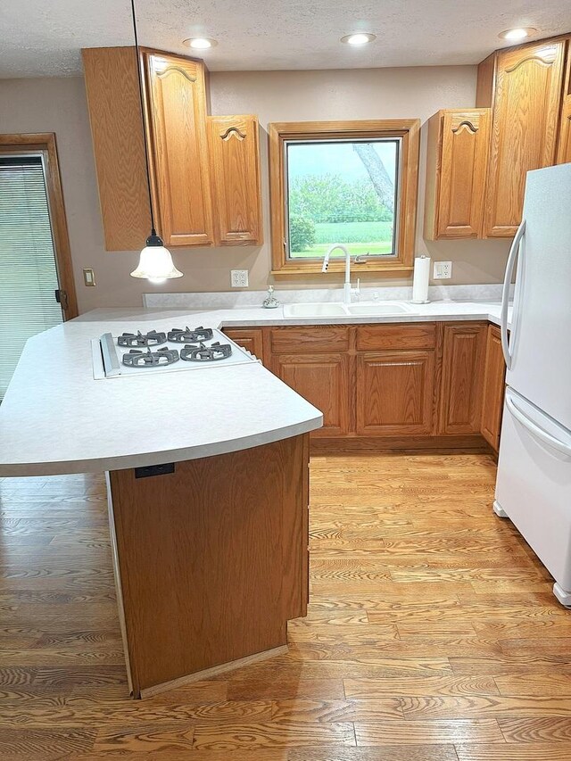 1417 S College Ave, Dixon, IL 61021 - kitchen featuring white appliances, a sink, light wood finished floors, light countertops, and recessed lighting
