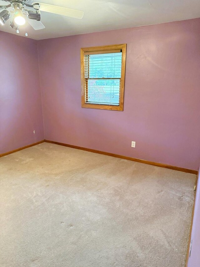 1417 S College Ave, Dixon, IL 61021 - empty room with ceiling fan, baseboards, and carpet