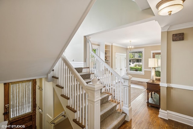 548 Cherry St, Winnetka, IL 60093 - stairway featuring wood finished floors, crown molding, a chandelier, and baseboards