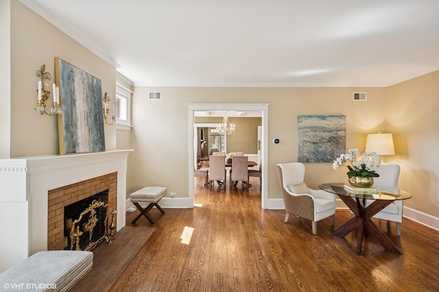 548 Cherry St, Winnetka, IL 60093 - sitting room featuring a chandelier, wood finished floors, ornamental molding, baseboards, and a brick fireplace