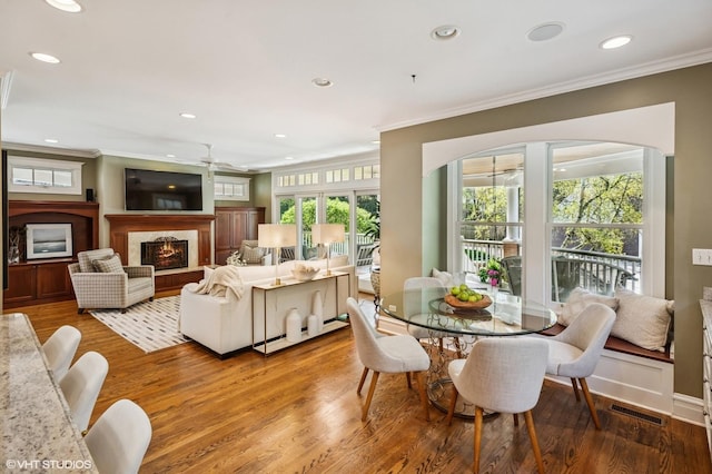 548 Cherry St, Winnetka, IL 60093 - dining area featuring ornamental molding, a ceiling fan, wood finished floors, recessed lighting, and a warm lit fireplace