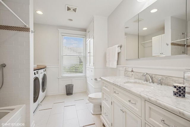 548 Cherry St, Winnetka, IL 60093 - full bathroom featuring washing machine and dryer, a shower, vanity, toilet, and tile patterned floors