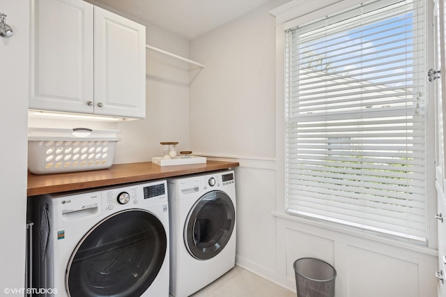 548 Cherry St, Winnetka, IL 60093 - laundry area featuring washing machine and dryer, cabinet space, a decorative wall, and wainscoting
