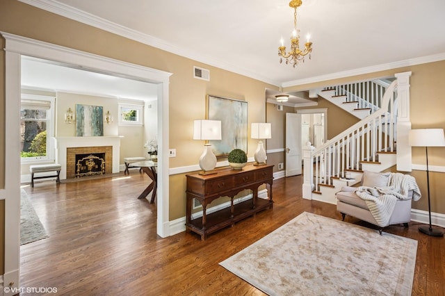 548 Cherry St, Winnetka, IL 60093 - living room with stairway, wood finished floors, a chandelier, crown molding, and a fireplace
