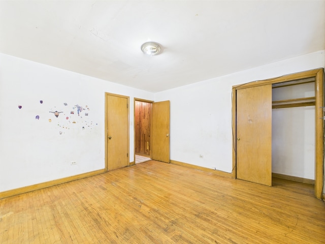 9216 S Ada St, Chicago, IL 60620 - unfurnished bedroom with light wood-type flooring, baseboards, and a closet
