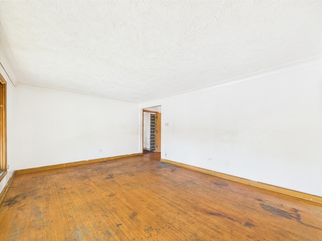 9216 S Ada St, Chicago, IL 60620 - spare room featuring a textured ceiling, baseboards, and wood finished floors