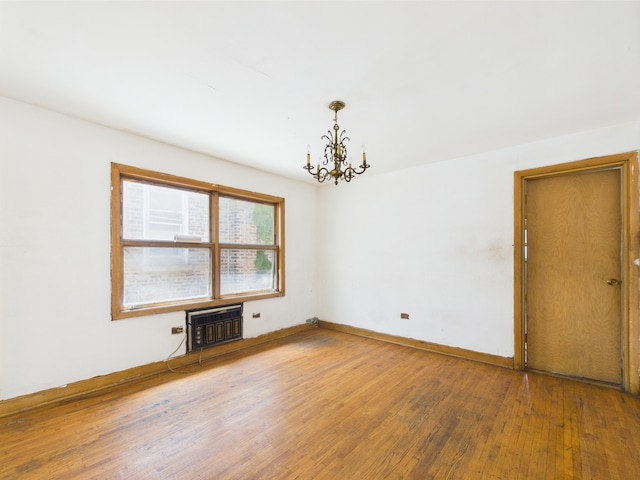 9216 S Ada St, Chicago, IL 60620 - unfurnished room with a chandelier, wood finished floors, heating unit, and baseboards