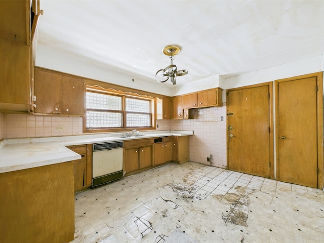 9216 S Ada St, Chicago, IL 60620 - kitchen with white dishwasher, brown cabinets, a sink, a chandelier, and light countertops
