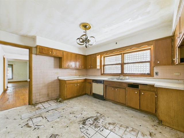 9216 S Ada St, Chicago, IL 60620 - kitchen with dishwasher, brown cabinetry, a sink, light countertops, and healthy amount of natural light